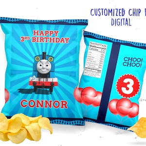 May include: A blue and red chip bag with a Thomas the Tank Engine design. The bag features a cartoon image of Thomas the Tank Engine, the words "Happy 3rd Birthday", and the name "Connor". The bag also has a nutrition facts label and a red circle with the number 3 inside.
