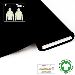 Könnte beinhalten: Schwarzer French Terry Stoff mit den Zertifizierungen Oeko-Tex Standard 100 und Global Organic Textile Standard (GOTS).
