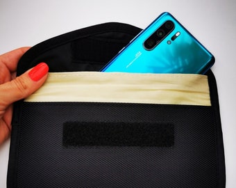 May include: A black fabric pouch with a velcro closure and a beige lining. A blue smartphone with a camera lens is inside the pouch.