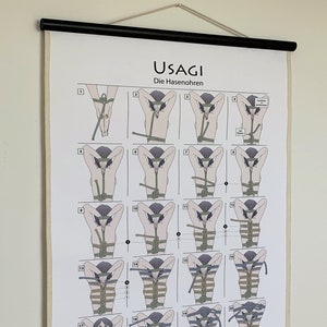 May include: A black and white illustrated guide to tying knots, titled "USAGI Die Hasenohren". The guide shows 26 different knots, each with a number and a step-by-step illustration of how to tie the knot.