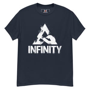 May include: A navy blue short-sleeved t-shirt featuring a white distressed graphic on the chest. The graphic displays a stylised triangular logo above the word INFINITY in a bold, weathered font. A small logo is printed inside the neck collar.