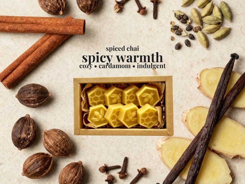 May include: A rectangular cardboard box containing eight yellow hexagonal wax melts, each embossed with a bee or honeycomb pattern. The text reads: spiced chai, spicy warmth, cozy, cardamom, indulgent. Surrounded by cinnamon sticks, cardamom pods, cloves, and ginger.