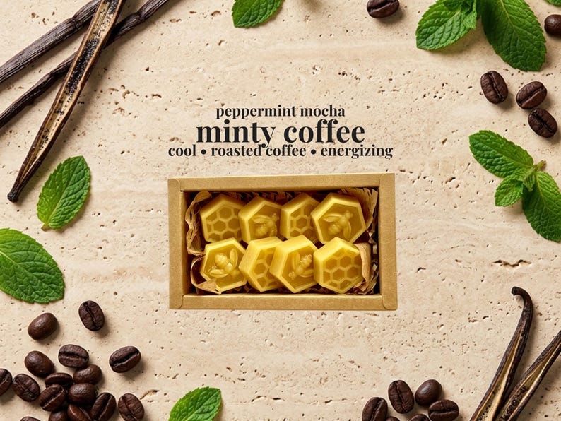 May include: A rectangular cardboard box containing eight yellow wax melts shaped like hexagons, featuring bee and honeycomb patterns. The text reads: peppermint mocha, minty coffee, cool, roasted coffee, energizing. Surrounded by coffee beans, mint leaves, and vanilla beans.