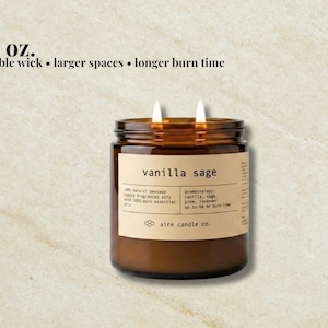 May include: A 16 oz. double wick candle in an amber glass jar with a beige label reading vanilla sage, 100% natural beeswax, aromatherapy: vanilla, sage, pine, lavender, up to 60 hr burn time, and aire candle co. Text above reads 16 oz. double wick.