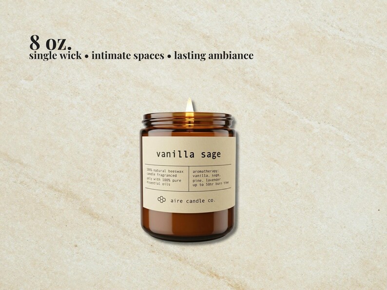 May include: An 8 oz. single wick candle in an amber glass jar with a beige label reading vanilla sage, 100% natural beeswax, and aire candle co. The candle features a lit wick and lists aromatherapy notes of vanilla, sage, pine, and lavender.