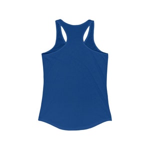May include: A royal blue racerback tank top. The sleeveless top features a scoop neck and a curved hemline. The back has a racerback design with thin straps that meet at the upper back. The fabric appears soft and lightweight.