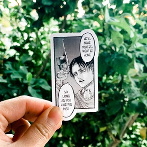 May include: A rectangular sticker featuring a black and white manga panel. The panel depicts a character holding a gun with speech bubbles that read, "We'll make you feel right at home" and "So long as you like pig piss."