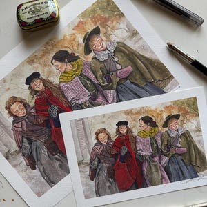 May include: Watercolour prints depicting women in period dress, strolling outside. The women are wearing capes, hats, and scarves in shades of red, green, and purple. A small tin and pens are also visible.