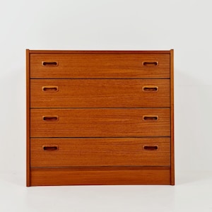 May include: A rectangular wooden chest of drawers featuring four horizontal drawers stacked vertically. Each drawer is equipped with two recessed, oval-shaped handles. The furniture piece has a warm, medium-brown wood grain finish throughout.