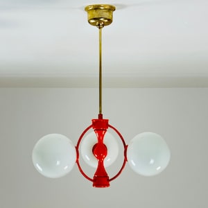 Mid century German Atomic orange Kaiser chandelier with 3 globes. 1960s