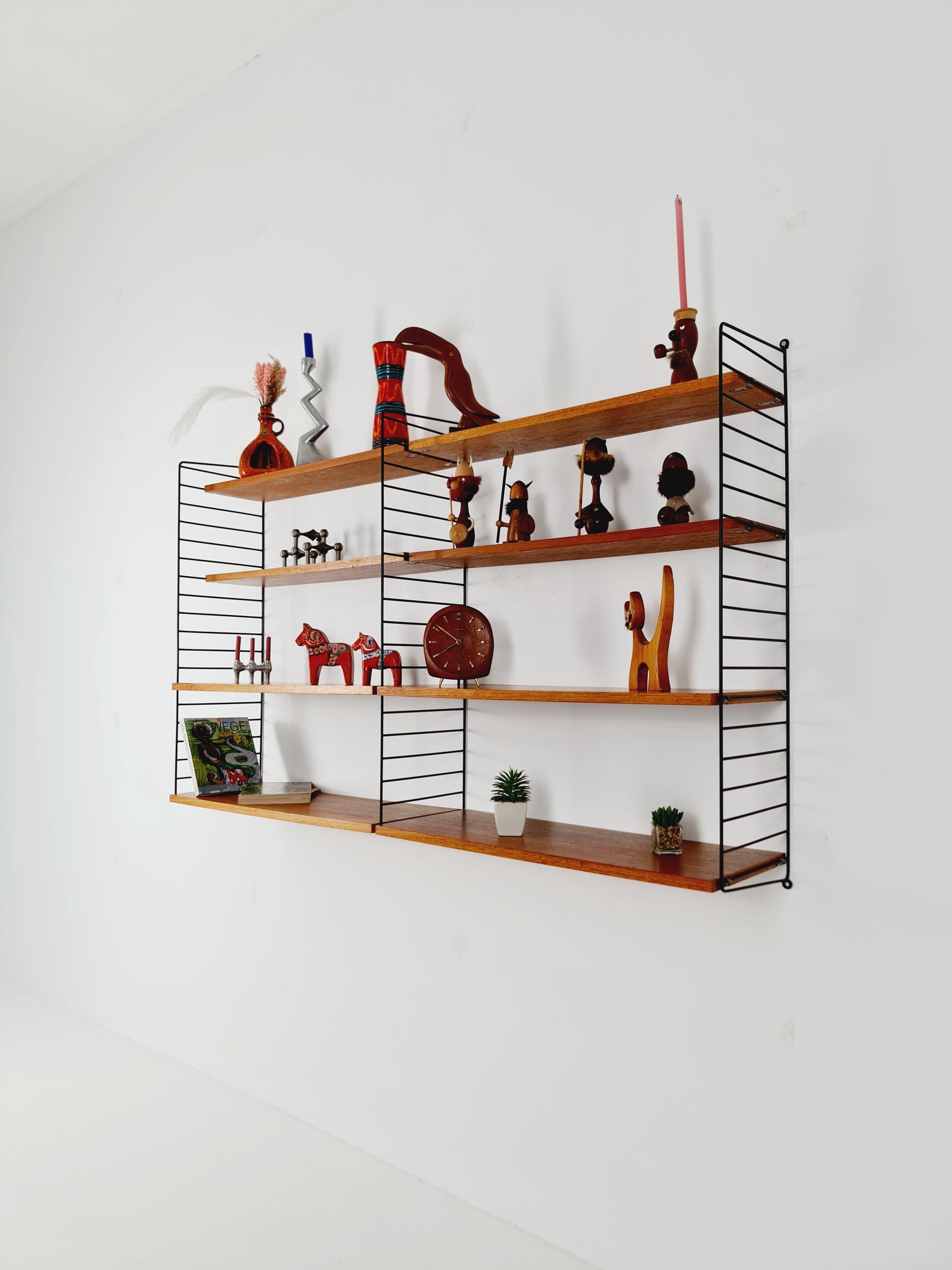 Original MCM Teak shelving system - consists of black lacquered metal ladders, from string Stockholm 1960s