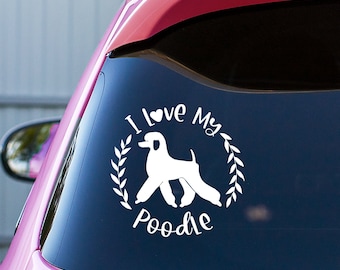 May include: White vinyl decal with a white poodle silhouette, a heart, and the text "I Love My Poodle" in a wreath.