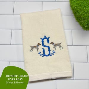 May include: Cream-colored hand towel with an embroidered blue letter "S" and two dog illustrations. The towel has a decorative border and the text "DEFAULT COLOR LIVER ROAN Silver & Brown" in a green shape.