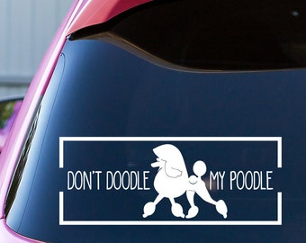 May include: White vinyl decal with a silhouette of a poodle and the text "Don't Doodle My Poodle" in a white rectangle.