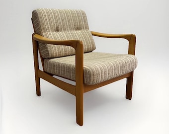 May include: A mid-century modern armchair with a light wood frame and striped upholstery in shades of beige and brown. The chair features a cushioned seat, back, and armrests, offering a comfortable seating option. The design is simple and elegant.