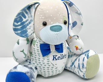 May include: A plush dog toy with a light tan head and ears, patterned with white stars and blue tie-dye. The dog has a blue bow tie and a heart-shaped patch embroidered with the name "Keller". The dog's body is patterned with blue and green shapes.