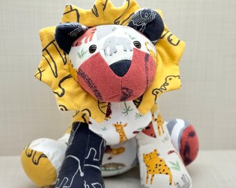 May include: A patchwork stuffed lion toy with a yellow mane. The lion is made from different fabrics with various animal prints, including elephants, giraffes, and leopards.