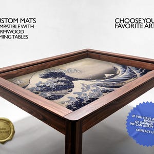 May include: A rectangular wooden gaming table featuring a recessed surface covered by a mat printed with The Great Wave off Kanagawa. Text on the image reads: CUSTOM MATS COMPATIBLE WITH WYRMWOOD GAMING TABLES, CHOOSE YOUR FAVORITE ART, and MADE IN-HOUSE.
