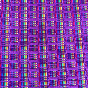 May include: Close-up of a woven textile with a repeating pattern. The base color is a vibrant purple, with woven sections of rainbow colors including red, orange, yellow, green, and blue. The texture appears soft and detailed.