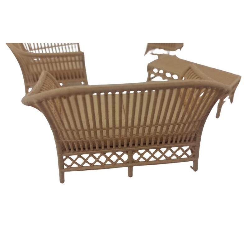May include: A miniature dollhouse furniture set featuring a light brown sofa with a slatted back and a lattice-patterned base, accompanied by a matching armchair and a rectangular table, all crafted with a consistent woven-style texture.