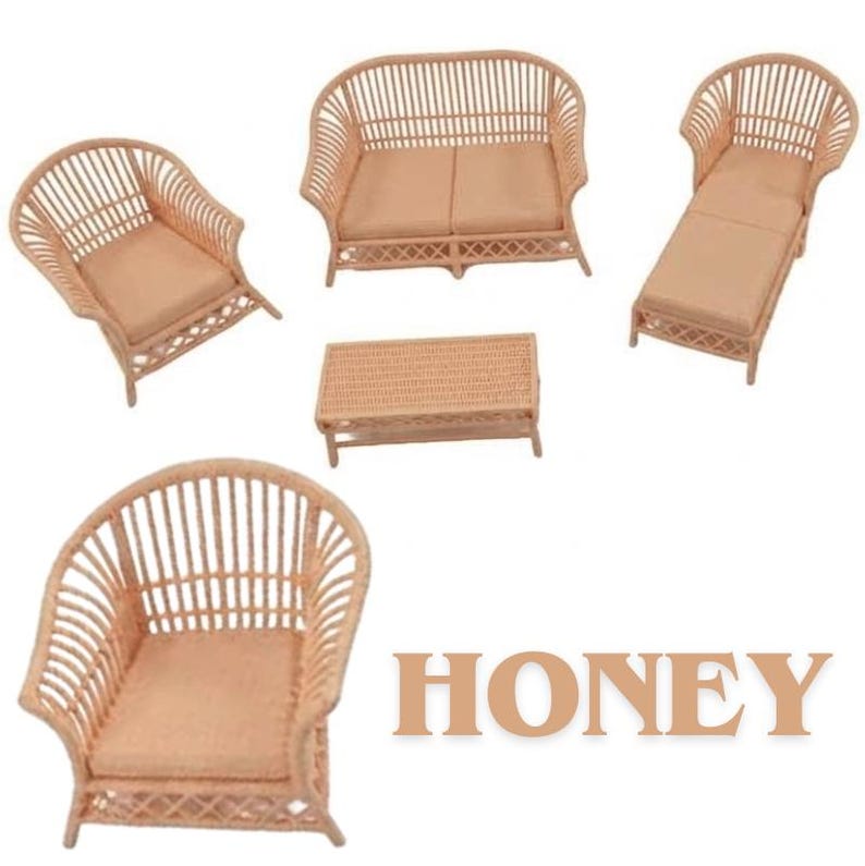 May include: A miniature furniture set in a light tan color, featuring a sofa, two armchairs, a chaise lounge, and a rectangular coffee table, all crafted with a slatted design and solid cushions. The word HONEY is printed in large tan letters.