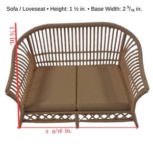 May include: A miniature beige sofa or loveseat with a slatted back and sides, featuring two flat seat cushions. Text indicates: Sofa / Loveseat &bull; Height: 1 1/2 in. &bull; Base Width: 2 9/16 in. The dimensions are visually marked with red lines.