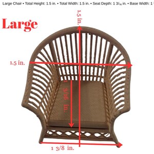 May include: A miniature light brown chair with a curved, slatted backrest and a flat seat. Red arrows and text indicate dimensions: total height 1.5 in., total width 1.5 in., seat depth 1 3/16 in., and base width 1 3/8 in. The word Large is visible.