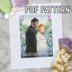 May include: A cross-stitch pattern featuring a couple kissing, with the word "BRIDGERTON" at the bottom. The words "PDF PATTERN" are at the top. The image is surrounded by floral accents and embroidery floss.