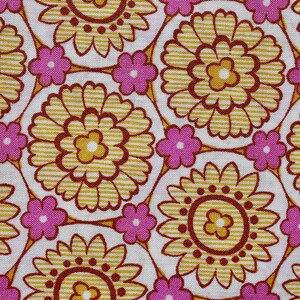 May include: Close-up of a fabric with a repeating floral pattern. The design features large, yellow flowers with brown centers and petals, surrounded by smaller pink flowers. The background is white.