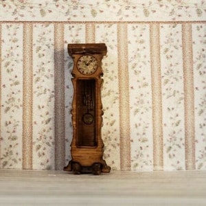 May include: A wooden grandfather clock with a white face and black hands. The clock is standing on a patterned wallpaper background.