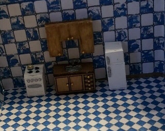 May include: A miniature dollhouse kitchen set with a white refrigerator, a stove, a sink, and cabinets. The kitchen is set against a blue and white checkered tile backdrop.