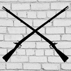 May include: Two black rifles crossed over each other against a white brick wall background.