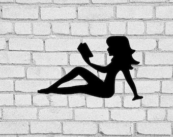 May include: A black silhouette of a person reclining and reading a book. The figure is positioned against a white brick wall. The person is seated with legs extended, holding the book up to read.