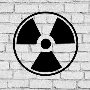 Puede incluir: Símbolo de radiación en blanco y negro sobre un fondo de pared de ladrillo blanco.