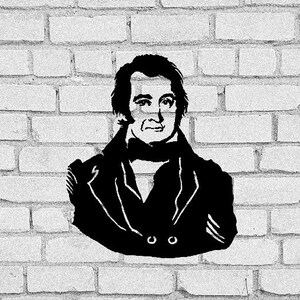 May include: A black and white stencil portrait of a man on a white brick wall. The man is depicted wearing a coat and a scarf. The image is a simple, graphic representation of a historical figure.