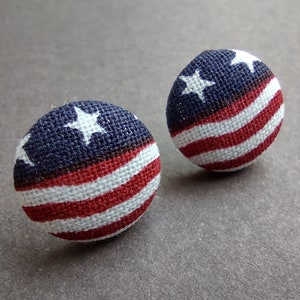 May include: A pair of red, white, and blue fabric button earrings with a star pattern.