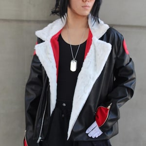 May include: A black leather jacket with a white faux fur collar and red accents. The jacket is worn over a black top and pants. The person is wearing red-tinted glasses and a silver dog tag necklace. The hair is black with red highlights.
