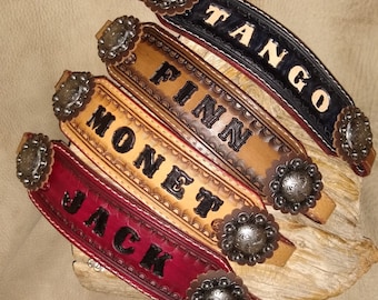 May include: Five leather wristbands with decorative metal accents and personalised names: Jack, Monet, Finn, Tango, and Jack.