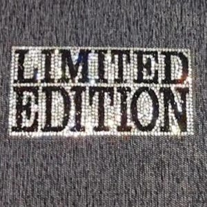 May include: A rectangular design with the words "LIMITED EDITION" spelled out in sparkling, light-colored rhinestones. The text is set against a textured, dark gray background.