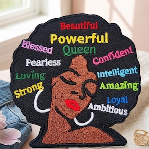 May include: Embroidered patch featuring a Black woman's silhouette with an afro. The patch is black with colorful text that reads "Beautiful, Powerful, Queen, Blessed, Fearless, Loving, Strong, Confident, Intelligent, Amazing, Loyal, Ambitious."