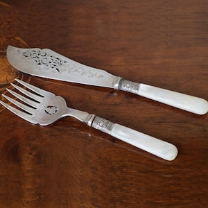 Antique pare of mother of pearl handled fish servers with sterling bands