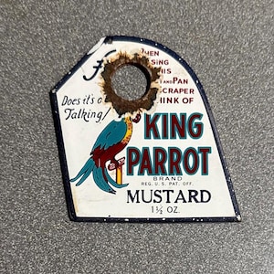 May include: Vintage King Parrot Mustard label with a parrot illustration. The label is white with a blue border and features text including "MUSTARD" and "1 1/2 OZ.". The parrot is depicted in blue, red, and yellow.