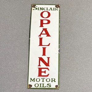 May include: Vintage Sinclair Opaline Motor Oils sign. The rectangular sign features the Sinclair logo at the top, with the word "OPALINE" in large red letters. The words "MOTOR OILS" are at the bottom.