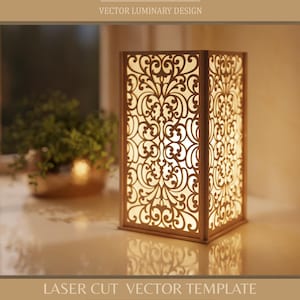 Puede incluir: Plantilla vectorial cortada con láser para un luminaria decorativa de madera. La lámpara rectangular presenta intrincados patrones florales y está iluminada desde el interior. El texto incluye formatos de archivo y una URL de la tienda.