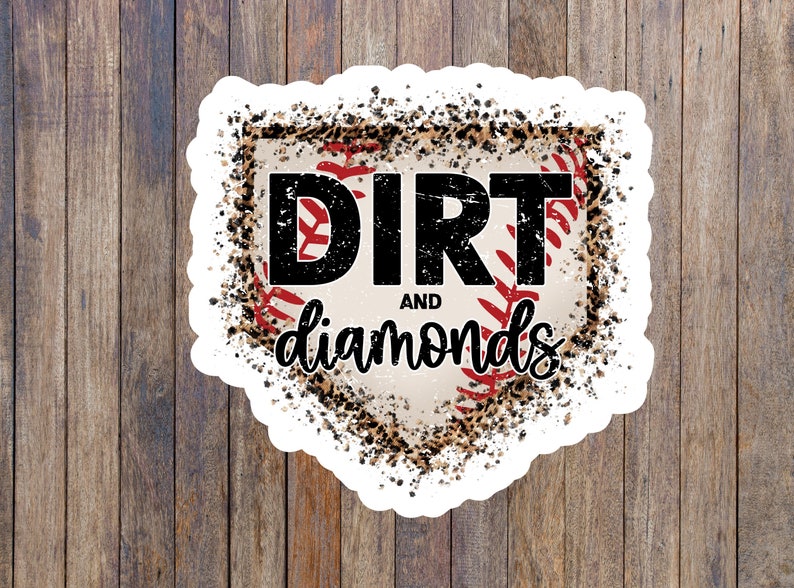 May include: A white sticker with a baseball diamond design. The diamond is filled with a brown and black leopard print and a red baseball with white stitching. The text "DIRT AND diamonds" is in black letters.