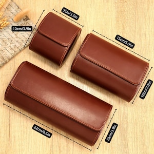 May include: Three brown leather cases with flap closures. The largest case measures 22 inches long, 3.9 inches high, and 3.9 inches deep. The medium case is 15 inches long, 3.9 inches high, and 3.9 inches deep. The smallest case is 3.5 inches long, 3.9 inches high, and 3.9 inches deep.