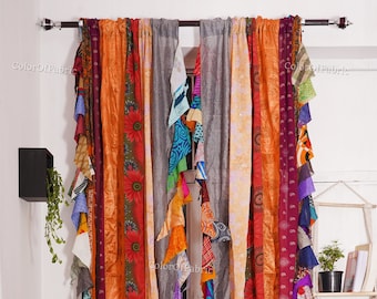 May include: A pair of colorful, multi-striped curtains made from recycled saris. The curtains are hung on a silver curtain rod and feature a variety of colors, including orange, red, purple, blue, and green.