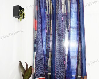 May include: A pair of blue and red patchwork curtains with a striped pattern. The curtains are made of sheer fabric and are hung on a curtain rod.