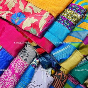 May include: A stack of colorful fabric scraps with various patterns and textures. The fabrics are arranged in a diagonal pattern, with the top layer being a bright yellow fabric. The fabrics are all cut into strips and sewn together.