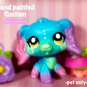 Peut inclure: Figurine personnalis&eacute;e peinte &agrave; la main d'un Cocker Spaniel aux couleurs de barbe &agrave; papa. Le chien jouet est principalement turquoise, avec des accents roses et violets. Le texte sur l'image indique "Hand painted Custom Cotton candy Cocker-spaniel >pet only<."